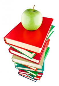 Stack of books with green apple on top
